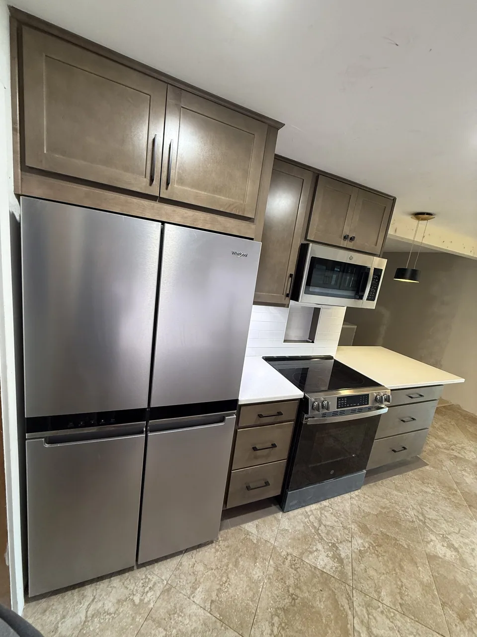 Solid-wood cabinet boxes staged on a Kingsley job site